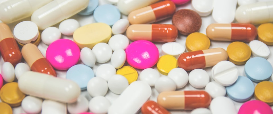 Assorted pills and capsules of different colors