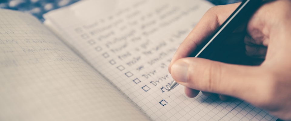 Checklist on paper with a pen
